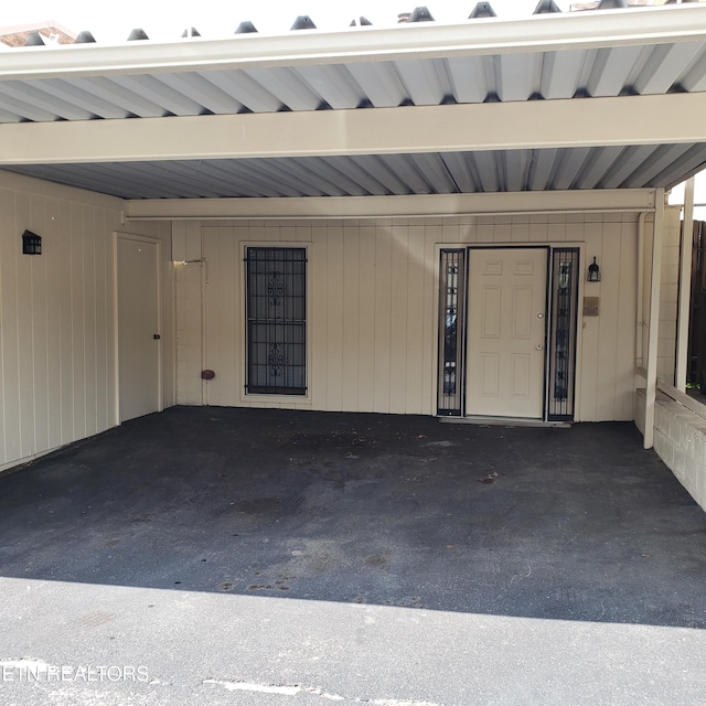 doorway to property featuring a carport