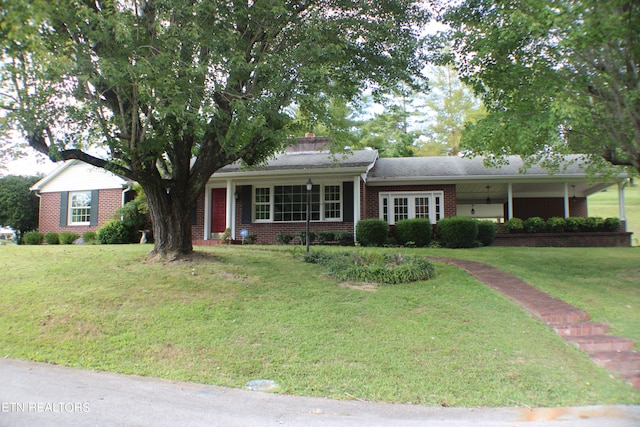 ranch-style house featuring brick siding and a front lawn