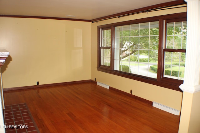 unfurnished room with ornamental molding, visible vents, plenty of natural light, and a baseboard radiator