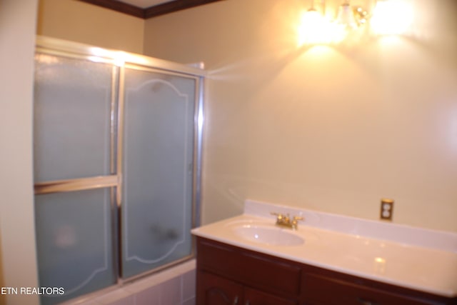 full bathroom featuring combined bath / shower with glass door and vanity
