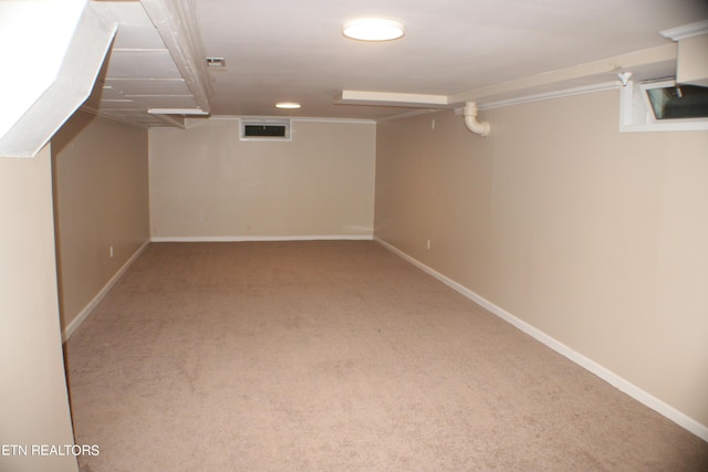 finished basement with carpet flooring, baseboards, and visible vents
