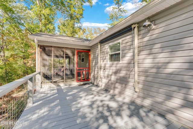 wooden deck featuring a sunroom