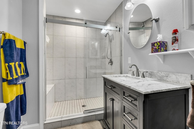 bathroom with vanity and a shower with door