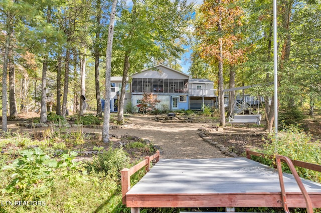 back of property featuring a wooden deck