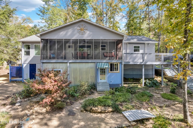 rear view of property with a sunroom