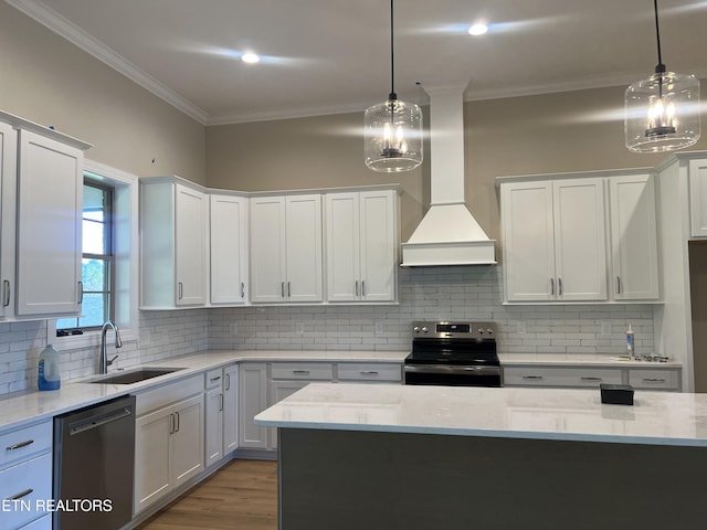 kitchen featuring pendant lighting, white cabinetry, sink, and stainless steel appliances