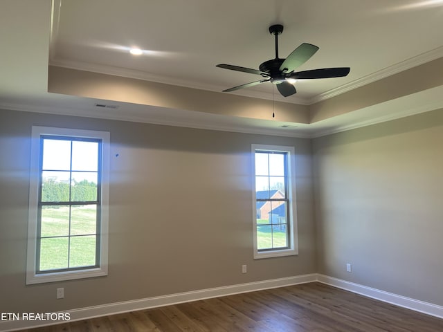 unfurnished room featuring dark hardwood / wood-style floors, plenty of natural light, ornamental molding, and ceiling fan