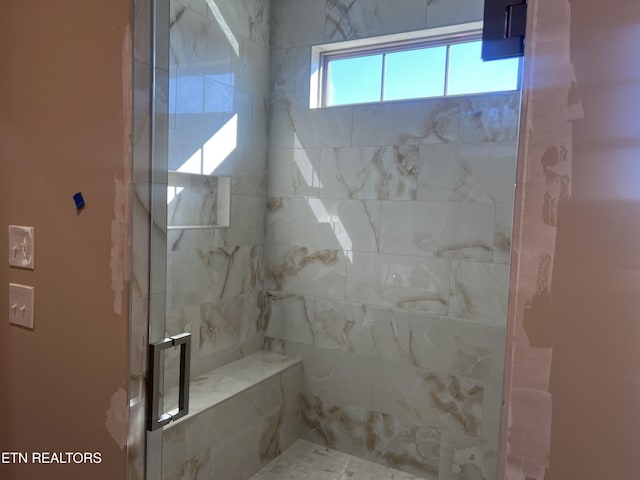 bathroom with a shower with shower door