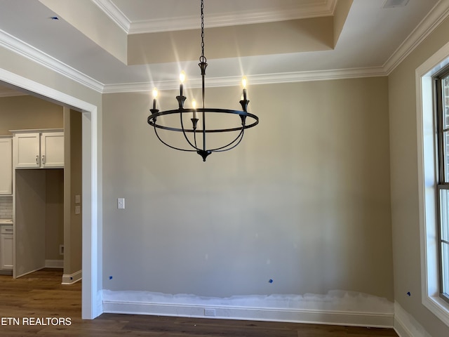 unfurnished dining area with a notable chandelier, dark hardwood / wood-style flooring, and crown molding