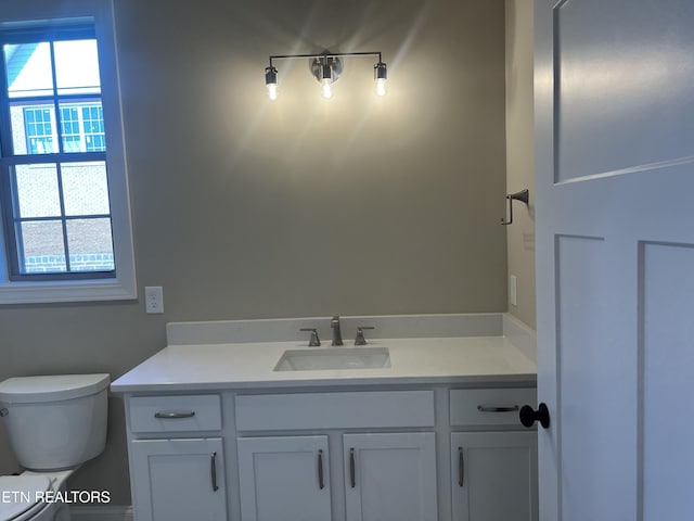 bathroom featuring vanity and toilet