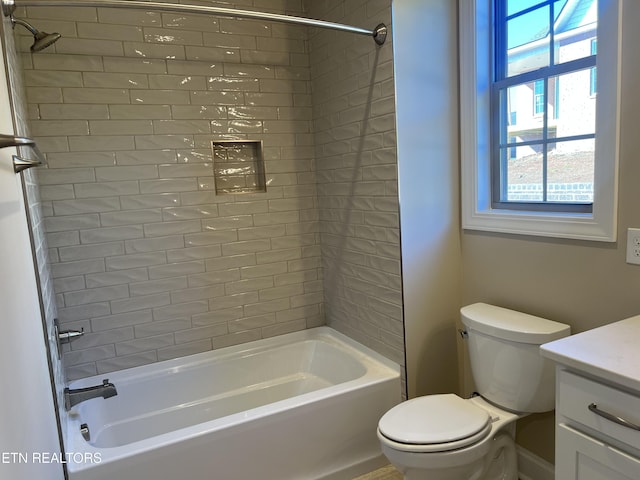 full bathroom with tiled shower / bath combo, toilet, and vanity