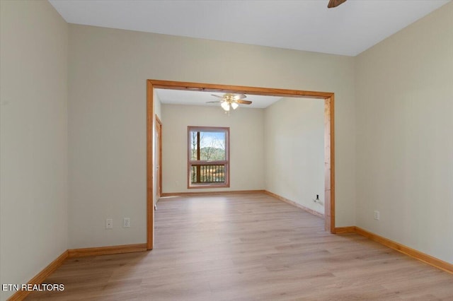 spare room with light wood-type flooring and ceiling fan