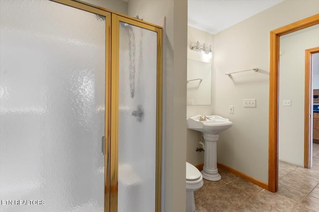 bathroom with tile patterned flooring, an enclosed shower, and toilet