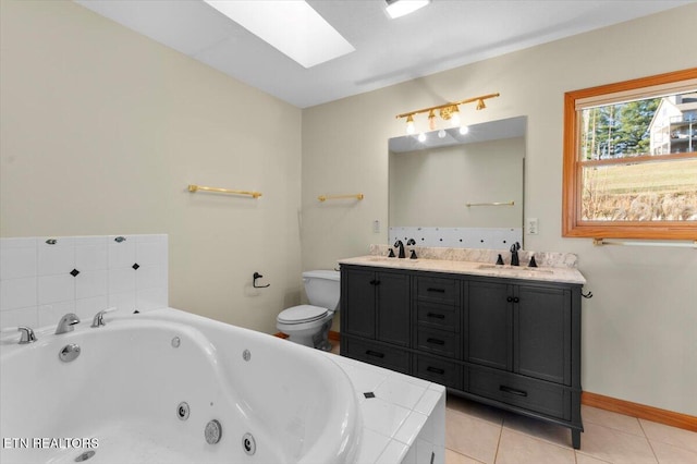 bathroom with tile patterned floors, toilet, tiled bath, and a skylight