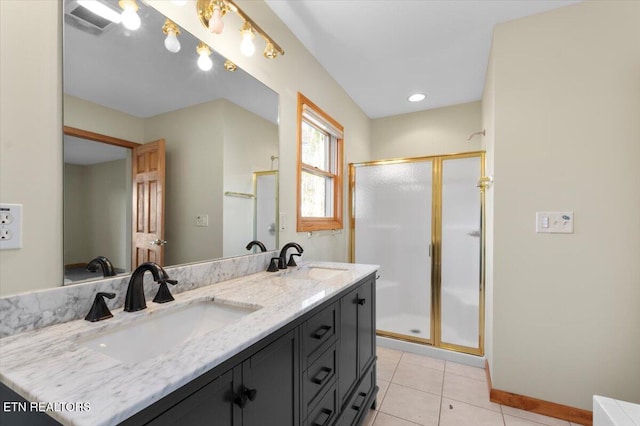 bathroom featuring tile patterned floors, vanity, and an enclosed shower