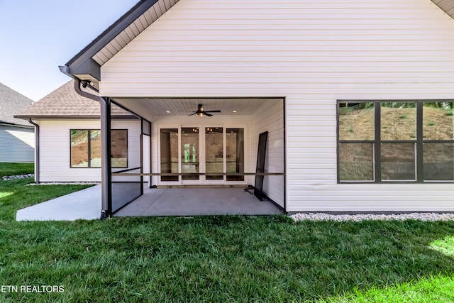 rear view of house with a patio area, ceiling fan, a yard, and a sunroom