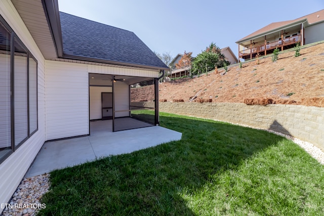 view of yard featuring a patio and ceiling fan