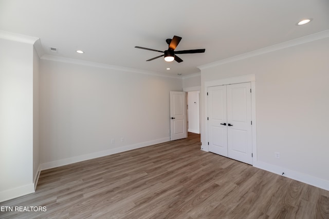 unfurnished bedroom with visible vents, baseboards, and wood finished floors