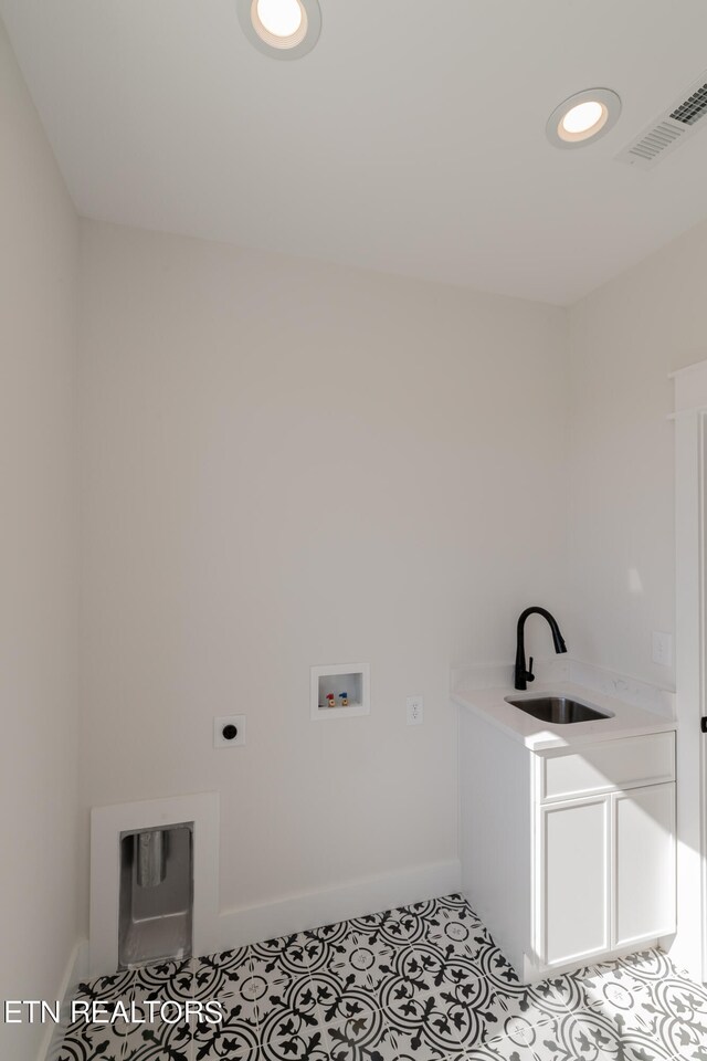 clothes washing area featuring visible vents, laundry area, hookup for a washing machine, electric dryer hookup, and a sink