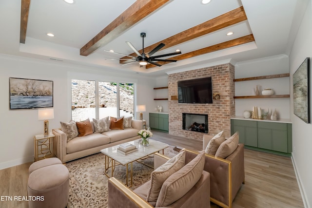 living room with a brick fireplace, baseboards, beamed ceiling, and light wood finished floors