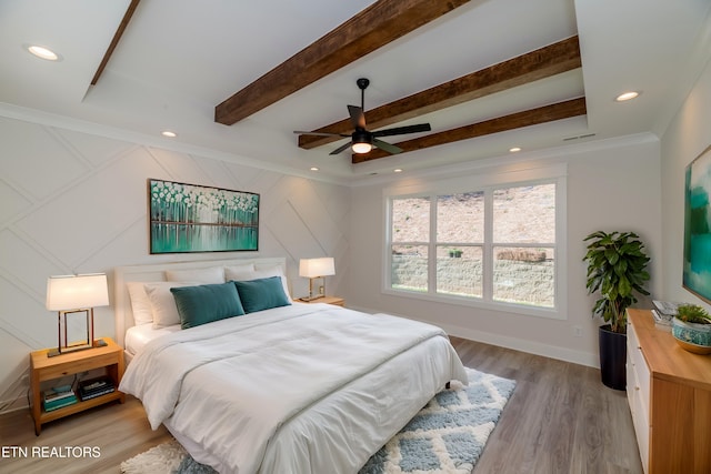 bedroom with beamed ceiling, recessed lighting, light wood-style floors, and baseboards