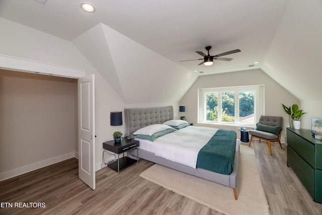 bedroom with baseboards, vaulted ceiling, recessed lighting, light wood-style flooring, and a ceiling fan