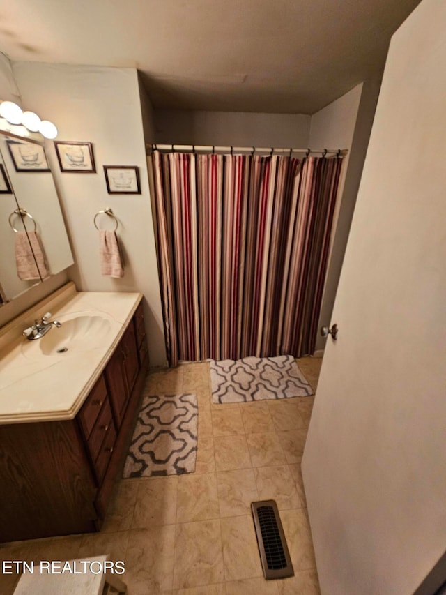 bathroom with vanity and curtained shower