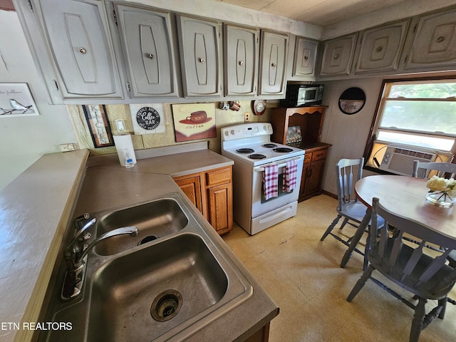 kitchen featuring white electric range oven and sink