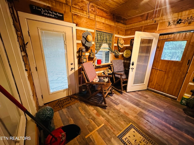 entryway featuring wooden walls, wood-type flooring, wooden ceiling, and french doors