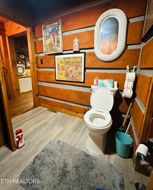 bathroom with wood-type flooring and toilet