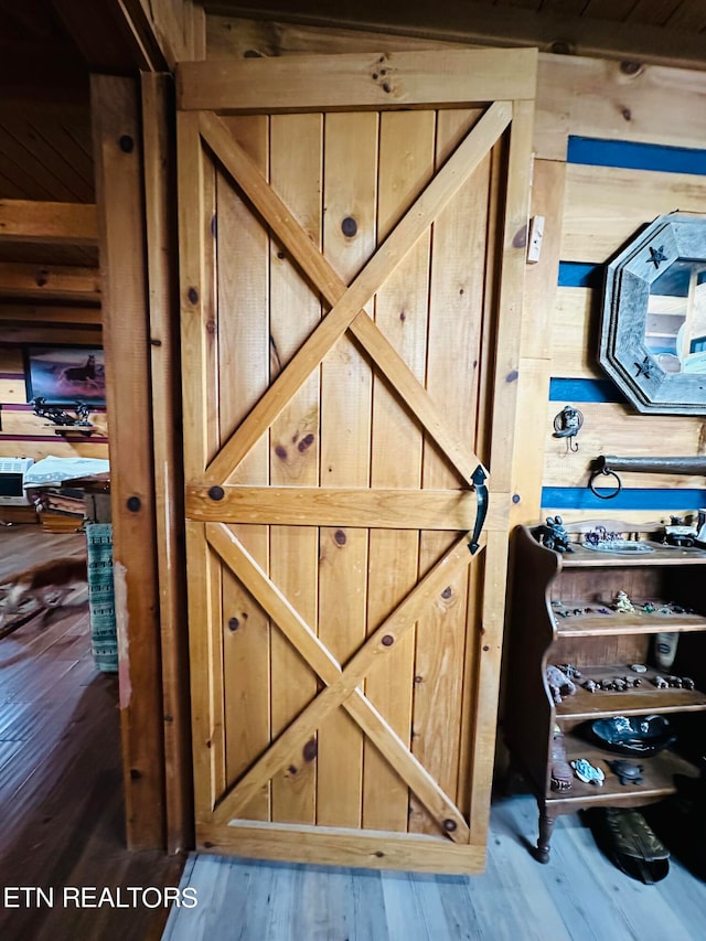 details featuring wooden walls and hardwood / wood-style flooring