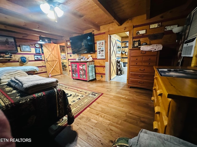 interior space with wooden ceiling, wood walls, beamed ceiling, and hardwood / wood-style flooring