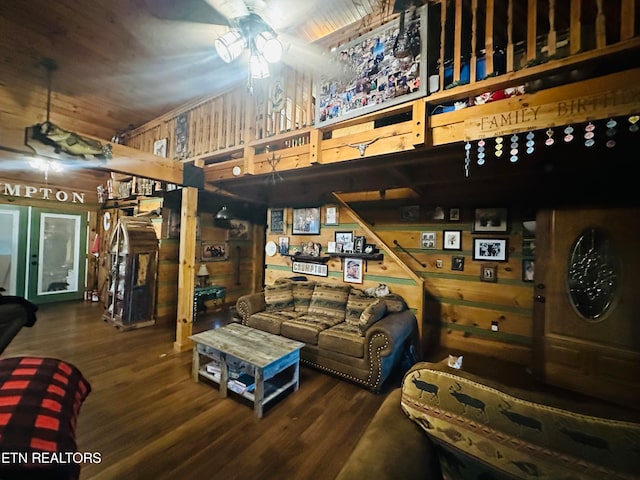 living room featuring wooden walls, ceiling fan, and hardwood / wood-style floors