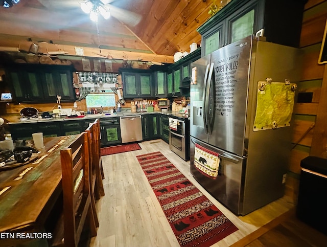 kitchen featuring ceiling fan, sink, appliances with stainless steel finishes, light wood-type flooring, and vaulted ceiling