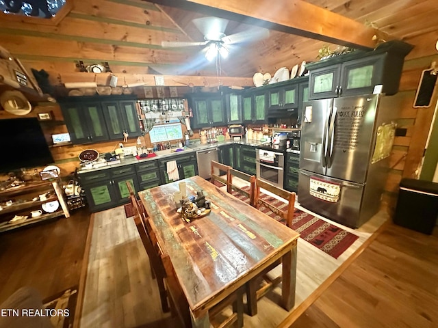 kitchen featuring light hardwood / wood-style flooring, stainless steel appliances, green cabinetry, and ceiling fan