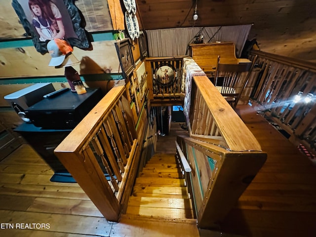 stairway with hardwood / wood-style floors