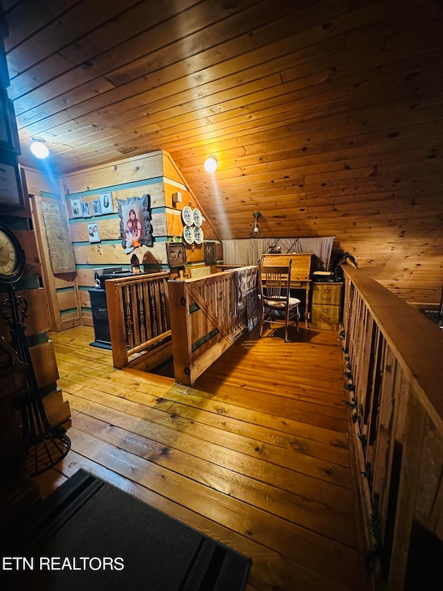 bonus room featuring wooden ceiling, lofted ceiling, wooden walls, and hardwood / wood-style floors