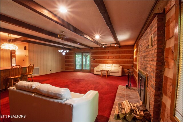 interior space with carpet floors, beamed ceiling, a notable chandelier, and a brick fireplace