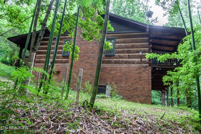 view of side of property featuring central air condition unit