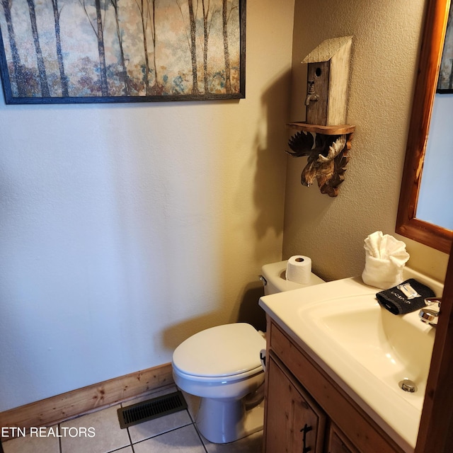 bathroom featuring tile patterned flooring, vanity, and toilet