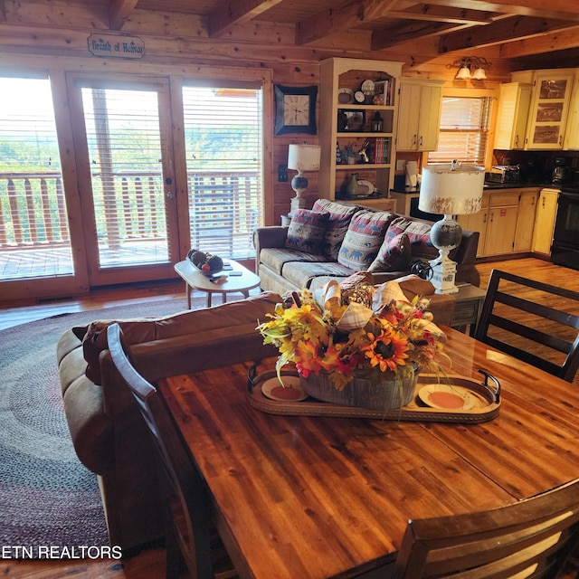 living room with beamed ceiling and hardwood / wood-style floors