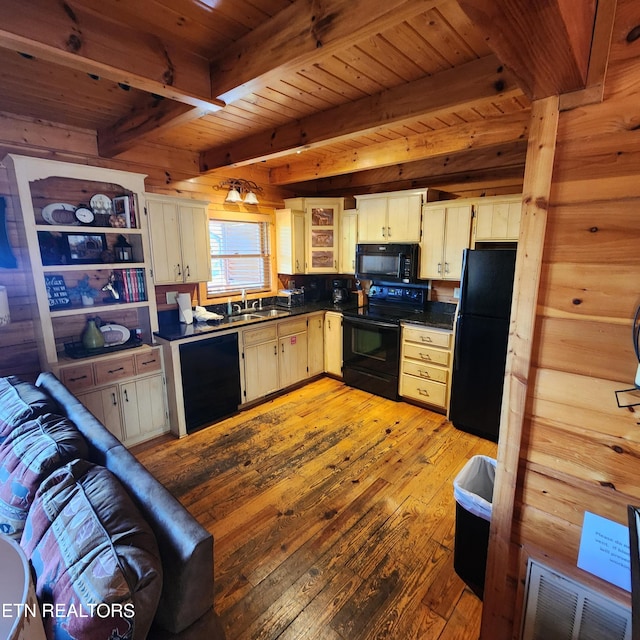 kitchen with beamed ceiling, light hardwood / wood-style flooring, wooden walls, black appliances, and wooden ceiling