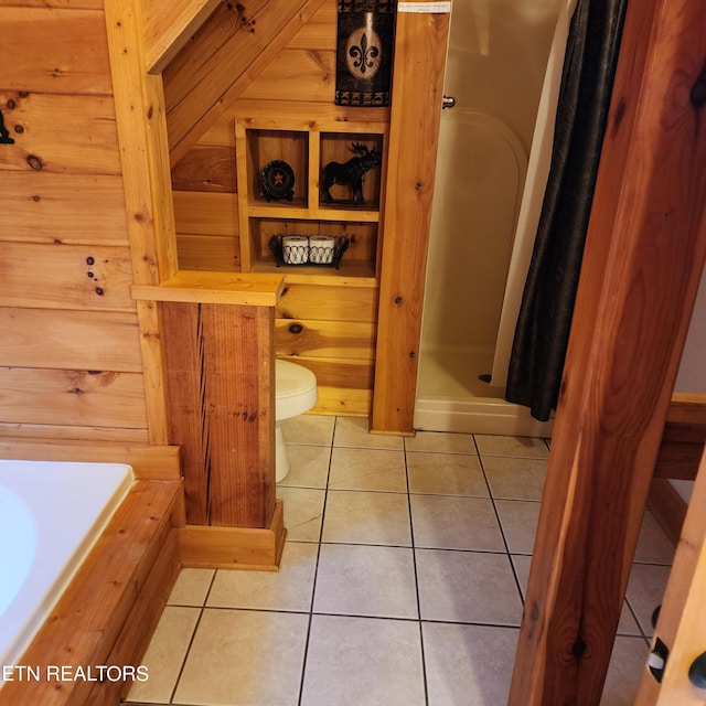 bathroom featuring a shower with curtain, wood walls, tile patterned floors, and toilet