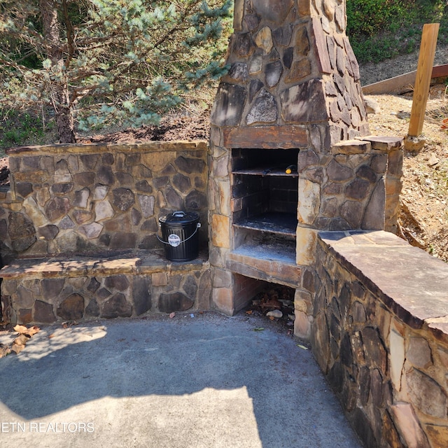 exterior space with an outdoor stone fireplace