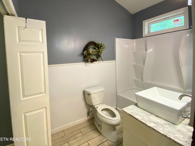 bathroom with vanity, toilet, walk in shower, and hardwood / wood-style floors