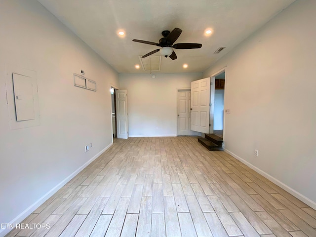 unfurnished bedroom with light hardwood / wood-style floors, electric panel, and ceiling fan