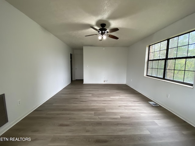 empty room featuring hardwood / wood-style floors and ceiling fan