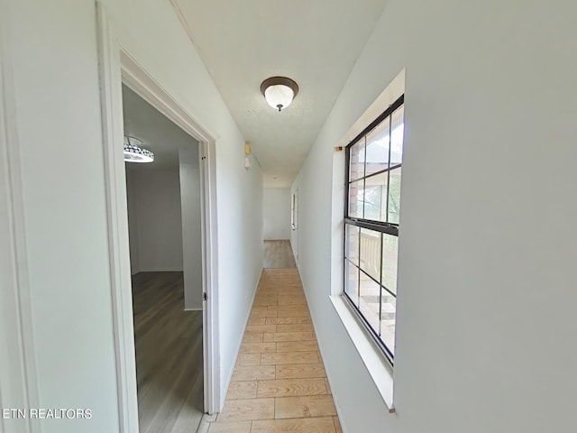 hallway with light hardwood / wood-style floors