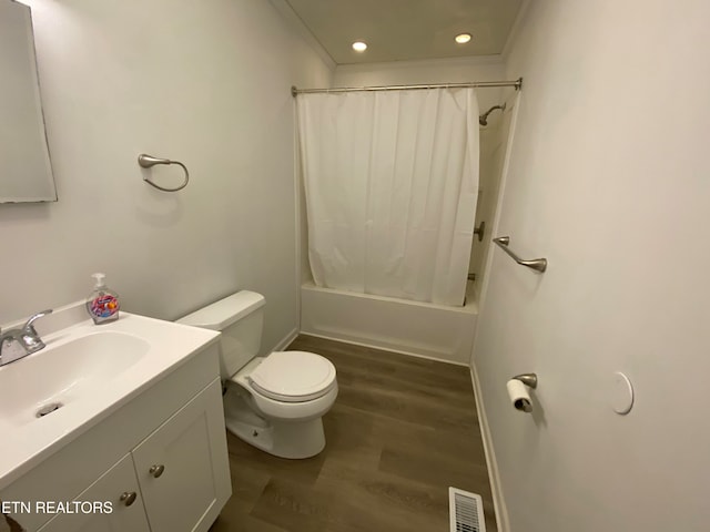 full bathroom with hardwood / wood-style flooring, toilet, shower / tub combo, ornamental molding, and vanity