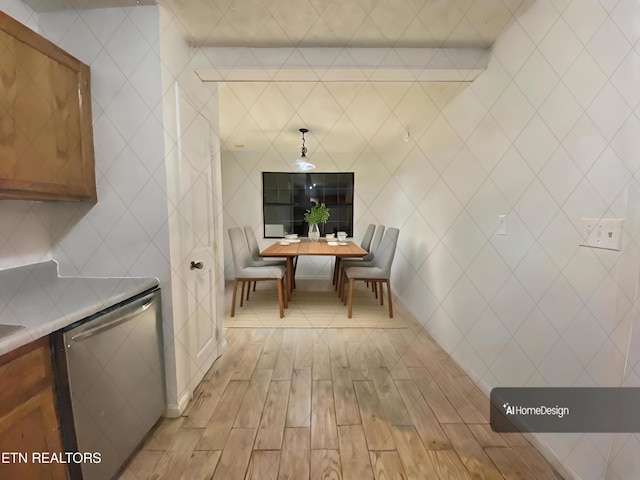 dining area with light hardwood / wood-style flooring and tile walls